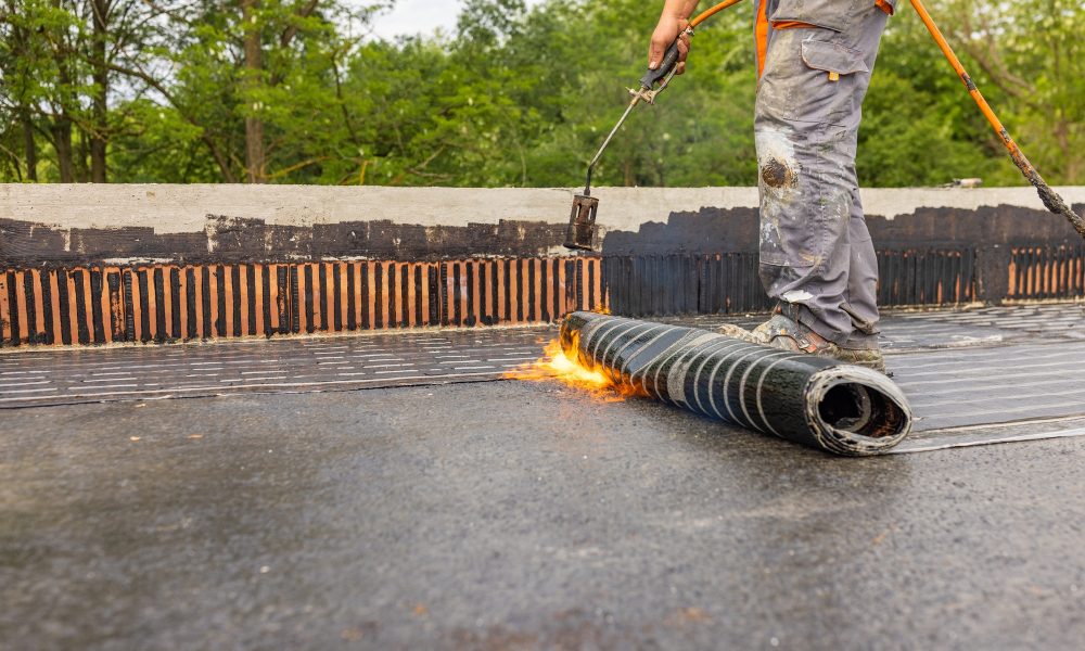 Bituminous membrane waterproofing system details and installation on flat rooftop.